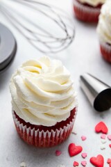 Red velvet cupcakes with cream cheese frosting on light background. Valentine's Day concept....