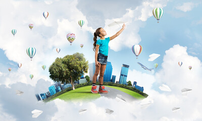 Concept of careless happy childhood with girl dreaming about future