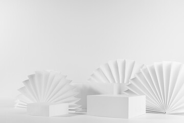 White abstract stage with three different rectangle stands mockup with circle ribbed paper fans in geometric style on table for showing, presentation cosmetic product or goods, side view, corner, 3d.