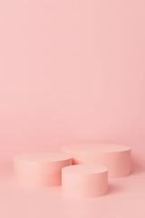 Elegant set of three pastel pink circle podiums mockup on soft light background, copy space, vertical. Template scene for advertising, presentation cosmetic product or goods, design.