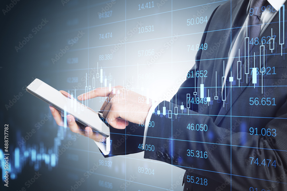 Poster Close up of businessman hand pointing at tablet with abstract glowing grid with index and candlestick forex chart. Trade and financial data concept. Double exposure.