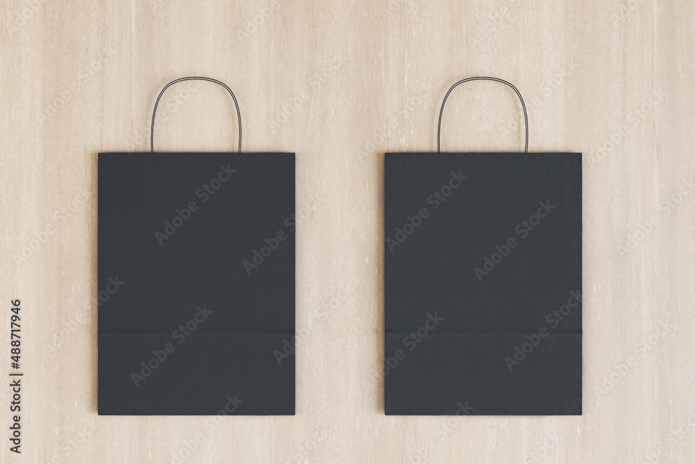 Poster close up of empty black paper bag on wooden backdrop. shopping concept. mock up, 3d rendering.