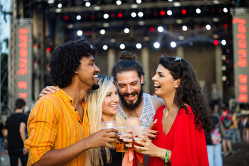 Happy young people attending festivals at summer having fun