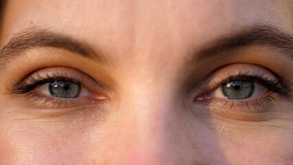 Fototapeta premium A close up portrait of beauty young beautiful woman's eyes, smiling looking at camera.