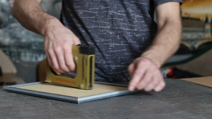 Framing Workshop. Making assembly stapler brackets baguette handmade picture frame at studio.