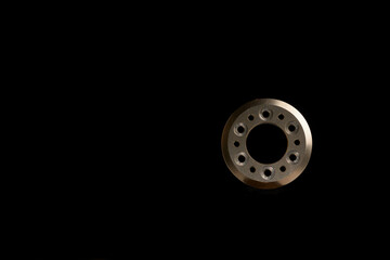 cap washer for a nut with side illumination on a black background