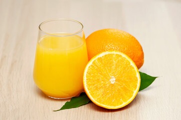 Naklejka na ściany i meble Fresh orange juice and fresh fruits on wooden table, closeup