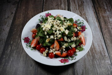 Traditional fresh and organic mixed vegetable salad serving on the plate. Mock up of luxury salad menu concept. 