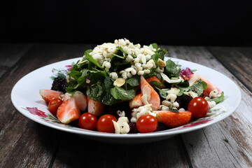 Traditional fresh and organic mixed vegetable salad serving on the plate. Mock up of luxury salad menu concept. 