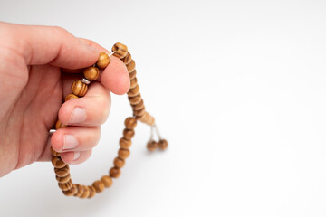 Hand holding a muslim rosary beads