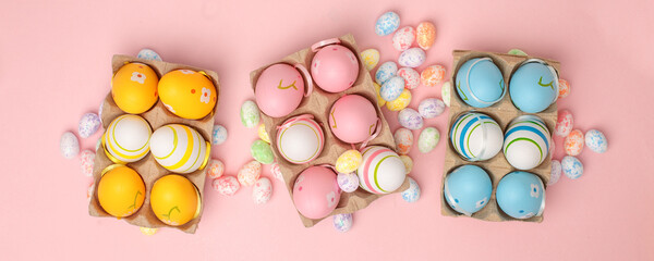 Top view shot of arrangement decoration Happy Easter holiday background concept. Flat lay colorful bunny eggs with ornament on pink paper, Design pastel tone. Banner, flyer, greeting card