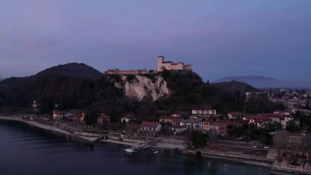 The city of Angera on Lake Maggiore at dusk, aerial parallax view.