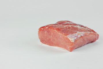 Red meat close up. Piece of pork isolated on a white background. Preparation for meat dishes. Copy space and free space for text near food.
