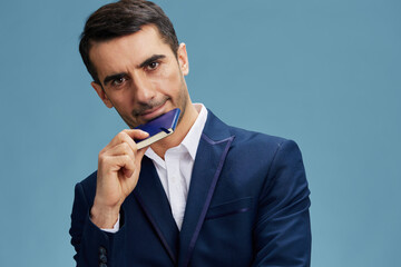 successful man with a thoughtful look blue suit notepad writing emotions business and office concept