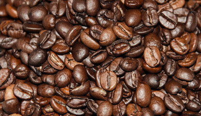 Background of roasted coffee beans close-up view from above.  Coffee beans close-up.
