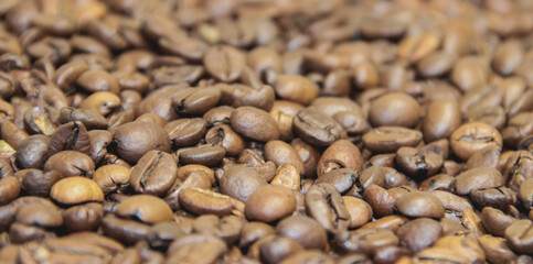 Background of roasted coffee beans close-up view from above.  Coffee beans close-up.