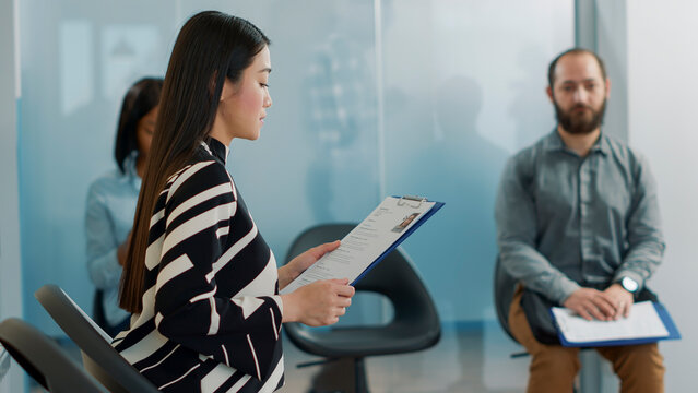 Pregnant worker inviting female applicant to attend job interview with HR team in company office. Candidate and employee joining employment meeting, having cv information files.