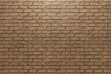 Front view of the rough brown brick wall.