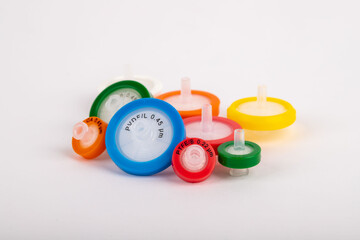 Colorful needlepoint filters standing on a white background. They are used in experiments in a...