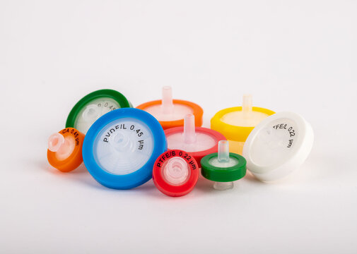 Colorful needlepoint filters standing on a white background. They are used in experiments in a laboratory environment.