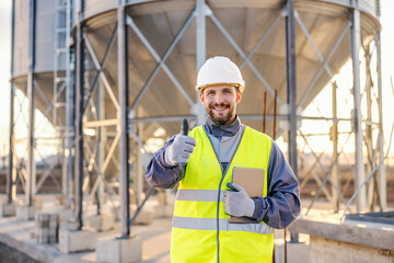 An industry supervisor visiting silos and giving thumbs up for supply.