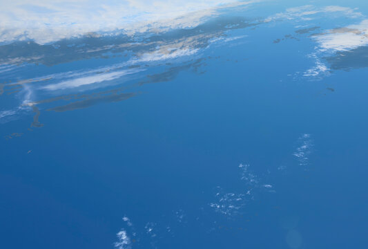 Abstract background of the view of the surface of the planet from space. Clouds, ocean and land. International day human space flight 12 April. The image was created from a photograph of the sky.