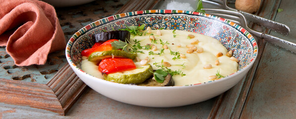plate with traditional Georgian mashed potatoes with vegetables on the table