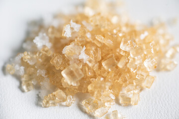 Brown sugar on spoon wood.