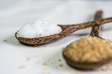 Brown sugar on spoon wood.