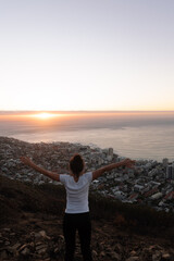 Young woman watching sunset in Cape Town. Tourist sightseeing in Cape Town, South Africa.