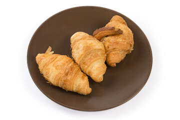 Small baked croissants on a brown dish