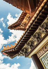 Fototapeta na wymiar Gable roof architecture against a blue sky background of Taiwanese temple-style at Fo Guang San Temple. Selective focus.