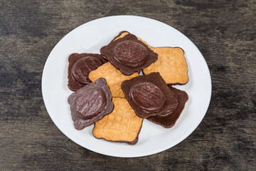 Cookies with chocolate coating on one side and jam filling