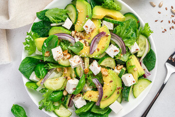 Avocado salad with feta and cucumber close-up.