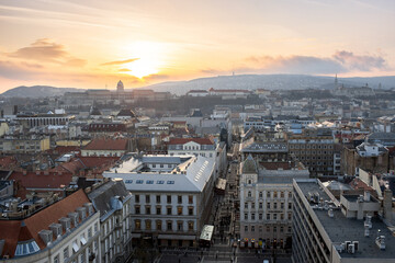Fototapeta na wymiar Budapest, Hungary - Panoramic view of Budapest from the colonade of St. Stephen's Basilica at sunset. View of the cathedral towers. Evening time.