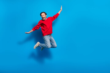 Fototapeta na wymiar Full length body size view of attractive cheery man jumping fooling having fun isolated over bright blue color background