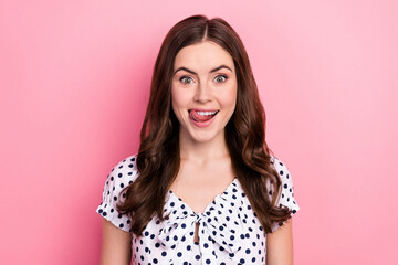 Portrait of attractive cheerful wavy-haired girl licking lip good mood isolated over pink pastel...