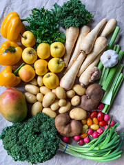 Healthy eating: grocery shopping or delivery of fresh fruits and vegetables. Rich vitamin vegetables. Variety of fruits and vegetables on craft paper. Fresh potatoes parsnips carrots apples kiwi peppe