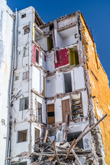 Fototapeta na wymiar building in ruin with a collapsed wall and visible damaged apartments
