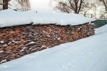 Log scraps of boards under thick layer of snow