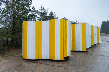 Naklejka premium Strand toilets. Yellow movable strand toilets in a row
