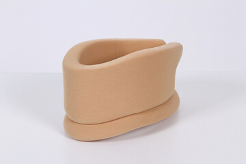 Beige orthopedic collar on neck isolated on white background. Medical support neck brace. Concept of cervical sprain and therapy. Traumatic head or neck injuries. Fixation. Spine fracture.