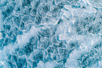Aerial top down view of ice surface. Frozen sea surface texture