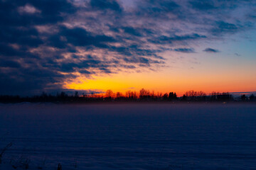 Winter sunset in the field . Winter landscape.