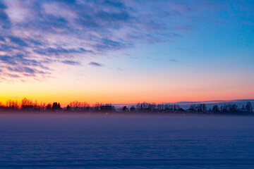 Winter sunset in the field . Winter landscape.