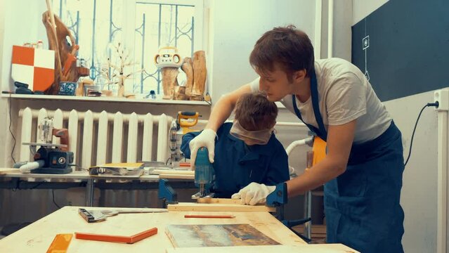 Child learns to cut wood with the Corded Top-Handle Jigsaw. Extra-curricular