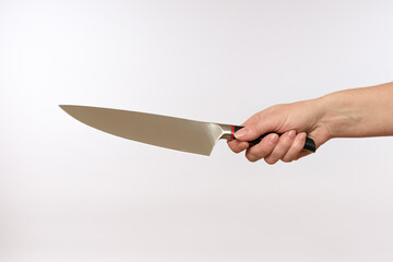 female hand holding a sharp steel knife on a white background, close-up