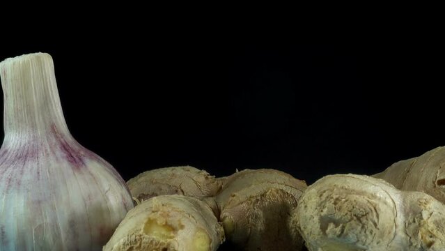 Ginger root with head of garlic rotate