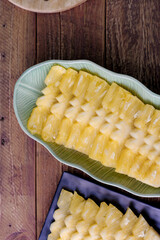 Top view Pineapple slices Asian-style on the wooden background.