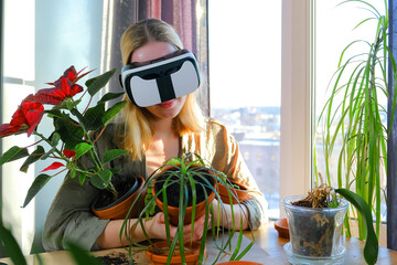 Gardening.Virtual world, metaverse.Girl planting flowers in immersive space VR.Home...